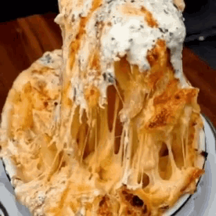 a close up of a plate of food with cheese coming out of it