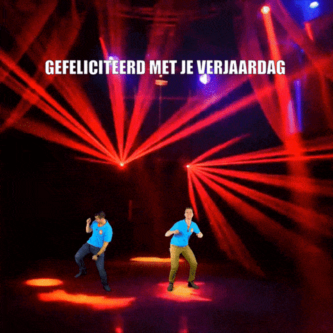 two men are dancing in front of a stage with the words gefeliciteerd met je verjaardag