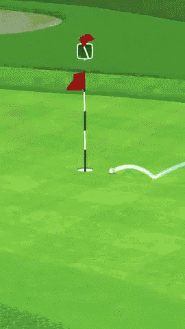 a green golf course with a red flag and a white ball