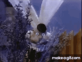 a cartoon character with wings is flying through the air .