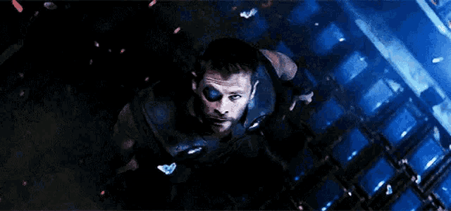 a man is flying through the air in a dark room .