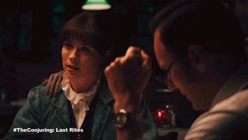 a man and a woman are sitting at a table with the conjuring last rites written on the bottom