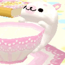 a white cat is sitting on top of a pink and white cup .