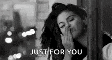 a black and white photo of a woman blowing a kiss and the words `` just for you '' .