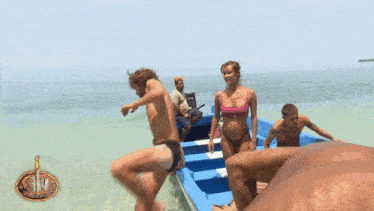 a group of people are in a boat on a beach with the letter s on the bottom