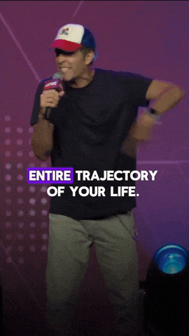 a man in a hat stands in front of a microphone with the words " entire trajectory of your life " below him