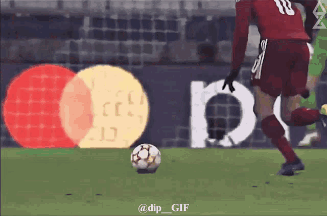 a soccer player with the number 18 on his jersey kicks a soccer ball