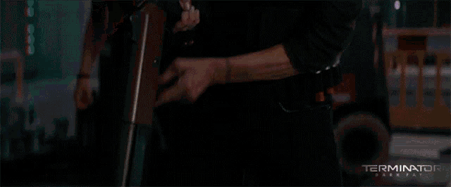 a poster for the movie terminator shows a man holding a gun