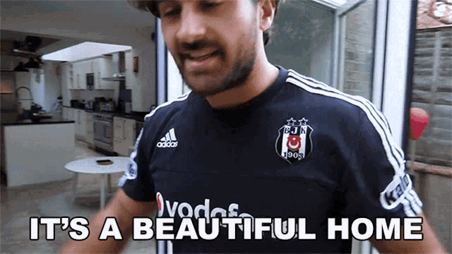 a man wearing a black adidas shirt says " it 's a beautiful home "