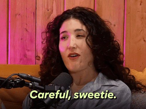 a woman sitting in front of a microphone with the words careful sweetie above her