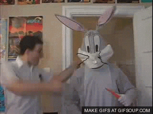 a man in a bugs bunny costume is standing next to another man in a white shirt