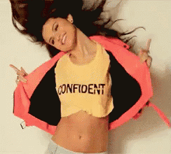 a woman wearing a yellow shirt that says confident on it