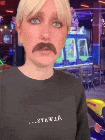 a woman with a fake mustache is wearing a shirt that says yawja