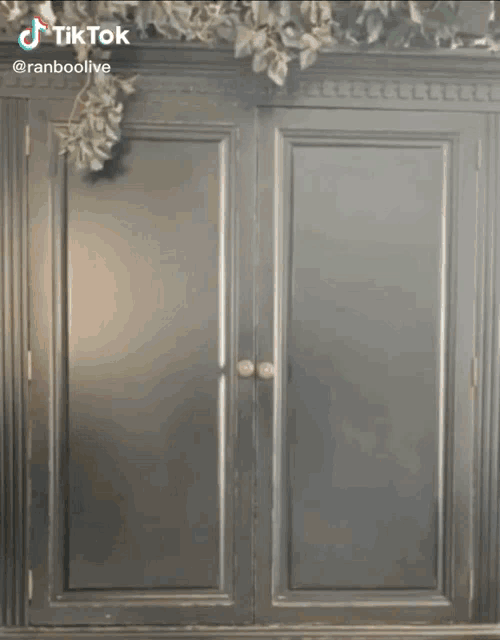 a man in a suit and tie is standing in front of a door .