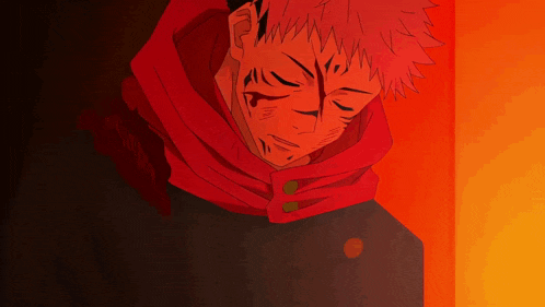 a man with red hair and a scarf around his neck is standing in a dark room .