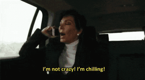 a woman is sitting in the back seat of a car talking on a cell phone and screaming .