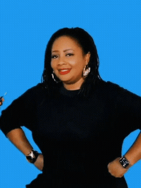 a woman is standing in front of a blue background and says uh oh !!!