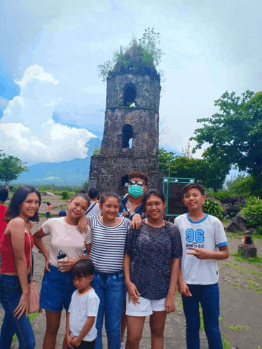 a group of people posing for a picture with one boy wearing a shirt with the number 96 on it
