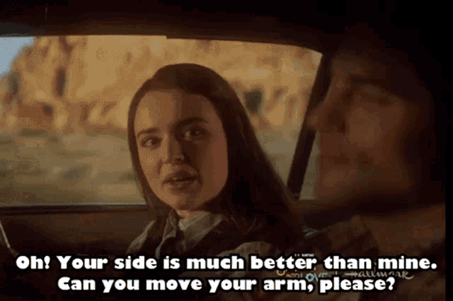 a man and a woman are sitting in a car and the woman is saying oh your side is much better than mine
