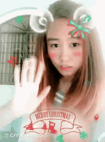 a girl with a merry christmas sticker on her hair