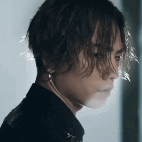 a close up of a person 's face with a black shirt on