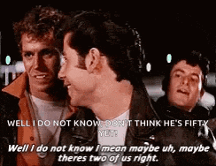 a group of men are standing next to each other and one of them is talking to another man .