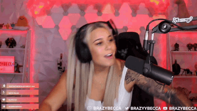 a woman wearing headphones stands in front of a microphone that says brazybecca on the bottom