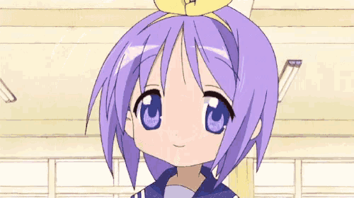 a little girl with purple hair and blue eyes is wearing a yellow headband .
