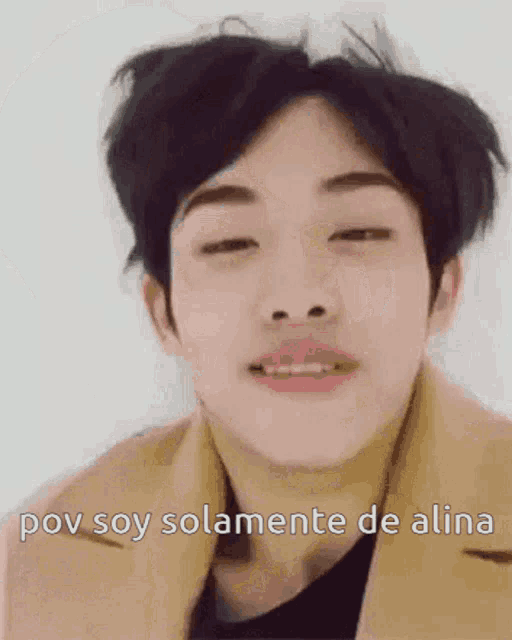 a close up of a man 's face with the words `` pov soy solamente de alina '' written below him .