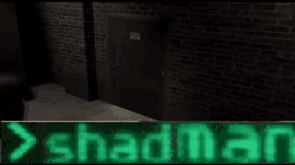a brick wall with a green sign that says shadman on it .