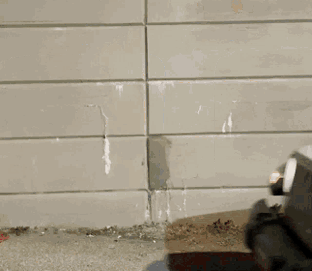 a white car is parked in front of a tiled wall .