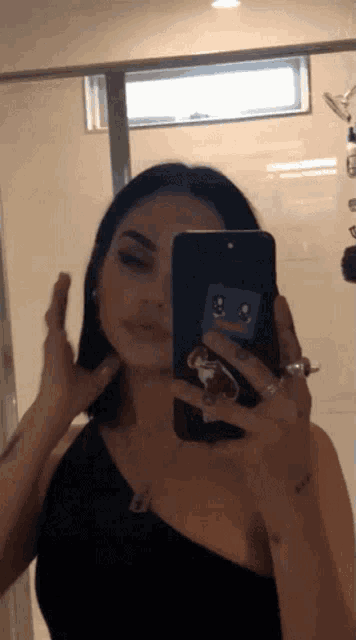 a woman is taking a picture of herself in a mirror
