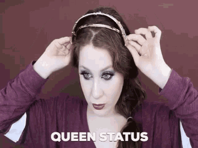 a woman is wearing a headband and the words queen status are on the bottom