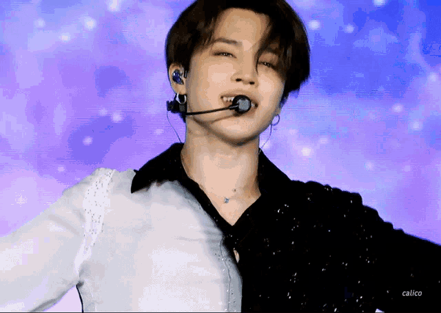 a close up of a person wearing a microphone and earphones