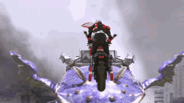 a person riding a motorcycle on top of a large purple object