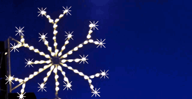 a snowflake shaped decoration with a blue background