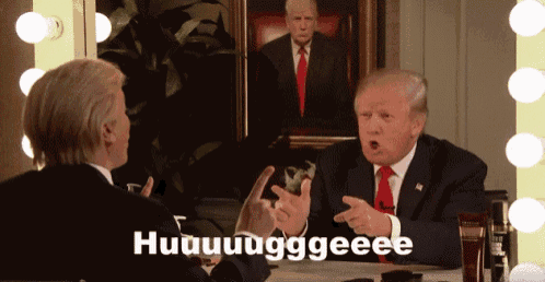a man in a suit and tie is talking to another man in front of a painting of trump