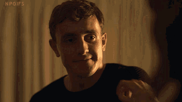 a close up of a man 's face with npgifs written on the bottom right