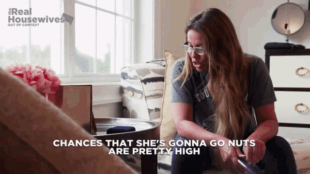 a woman sitting on a couch with the words chances that she 's gonna go nuts are pretty high above her
