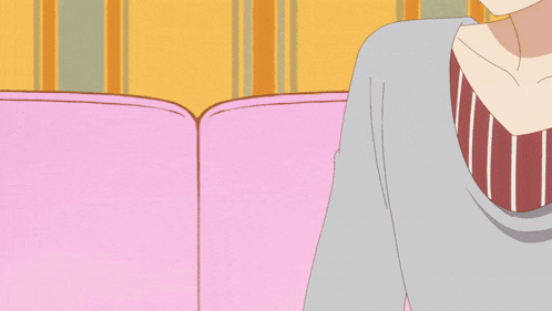 a girl with long green hair is laying on a pink couch