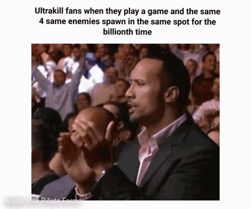 a group of people are sitting in a stadium watching a game and the rock is clapping .