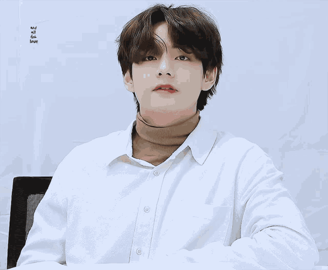 a man in a white shirt has the word love on the bottom