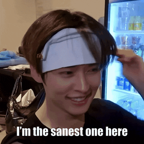 a man wearing a headband with the words i 'm the sanest one here written on it