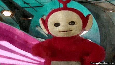 a red teletubbies doll is standing in front of a pink wall
