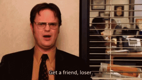 a man in a suit and tie is standing in front of a window and saying `` get a friend , loser '' .