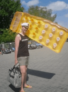 a woman wearing a tank top that says o'neill is holding a large inflatable raft