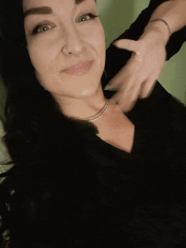 a woman wearing a black shirt with hello written on it