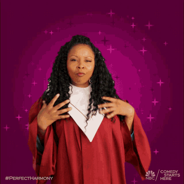 a woman in a red gown with a white collar stands in front of a purple background with stars