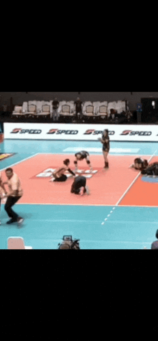 a volleyball game is being played in front of a sign that says ' speed '