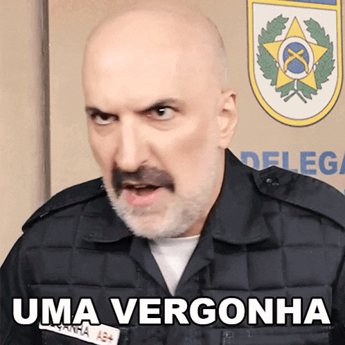 a bald man with a beard and mustache is wearing a uniform that says uma vergonha on it